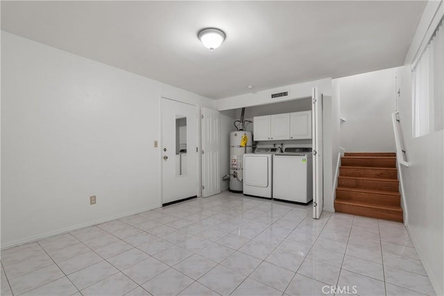 laundry area featuring washing machine and dryer, secured water heater, and cabinets