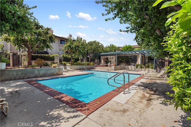 view of swimming pool featuring a pergola and a patio