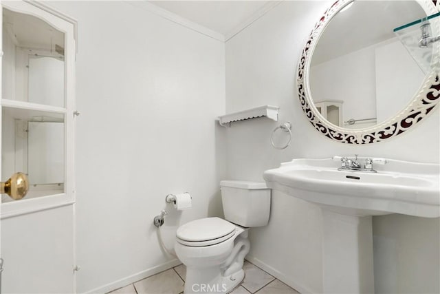 bathroom with toilet, tile patterned floors, and ornamental molding