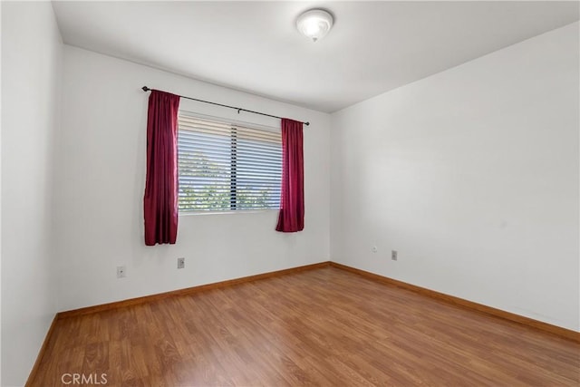 empty room with hardwood / wood-style flooring