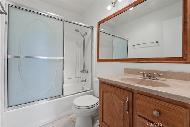 full bathroom featuring toilet, vanity, tile patterned flooring, and shower / bath combination with glass door