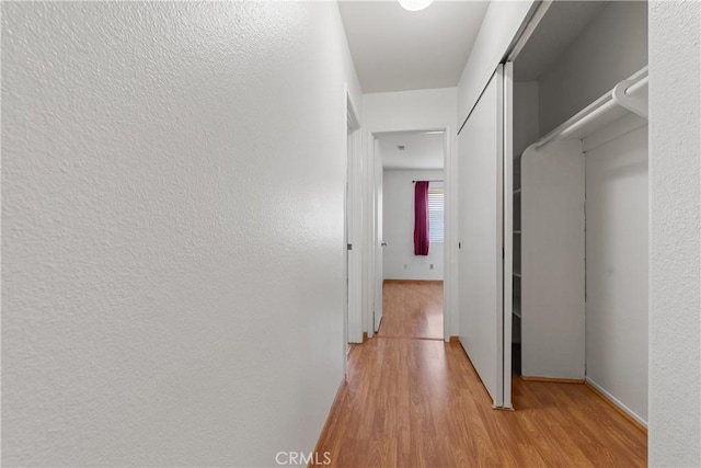 hallway with light hardwood / wood-style flooring