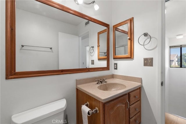 bathroom with toilet and vanity