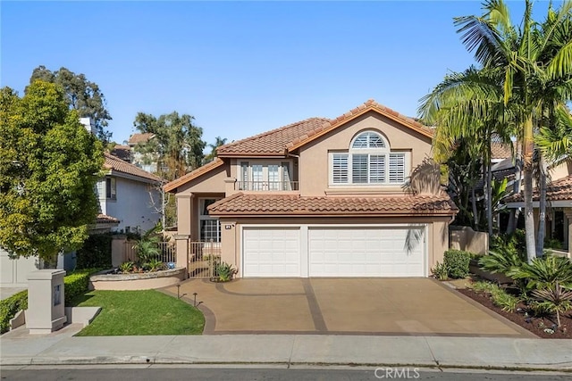 mediterranean / spanish-style house with a garage