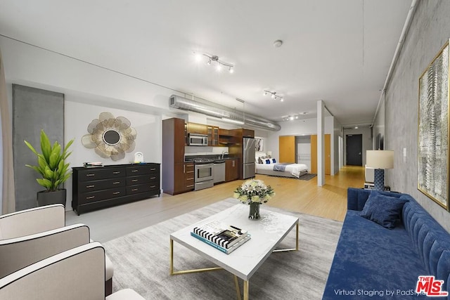 living room featuring light hardwood / wood-style floors and sink