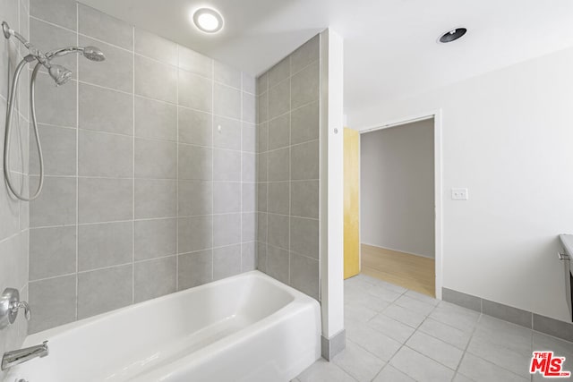 bathroom with tiled shower / bath and tile patterned floors