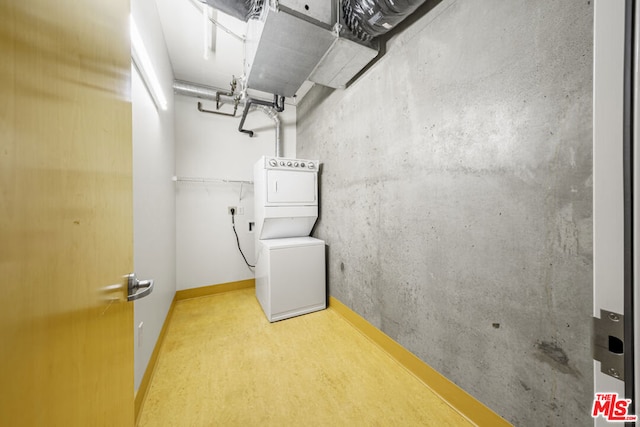 washroom featuring stacked washer and dryer