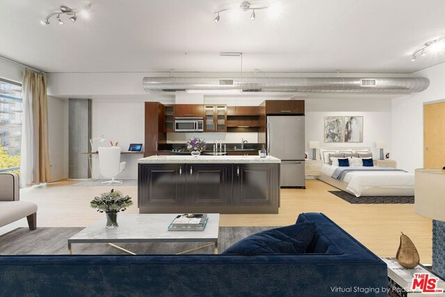 living room with sink and light hardwood / wood-style floors