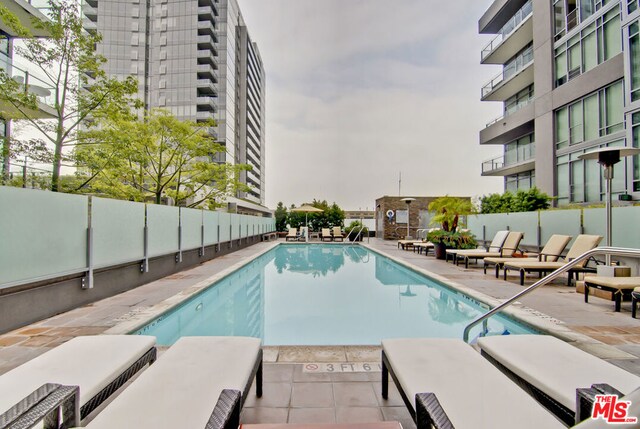 view of swimming pool with a patio area