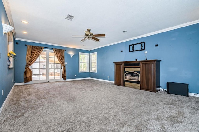 unfurnished living room featuring ceiling fan, carpet, and crown molding