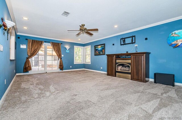 unfurnished living room featuring ceiling fan, carpet, and crown molding