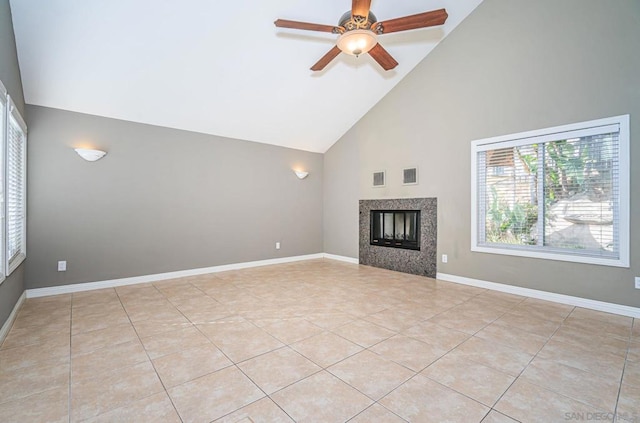 unfurnished living room with ceiling fan, light tile patterned flooring, and high vaulted ceiling