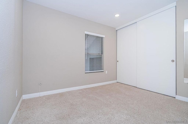 unfurnished bedroom with a closet and carpet flooring