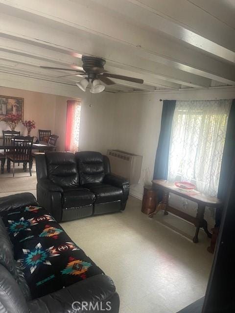 living room with ceiling fan and beamed ceiling