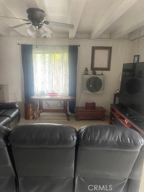 living room featuring ceiling fan and beam ceiling