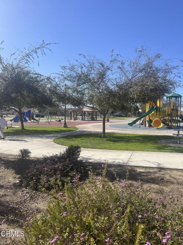 view of community featuring a playground and a yard