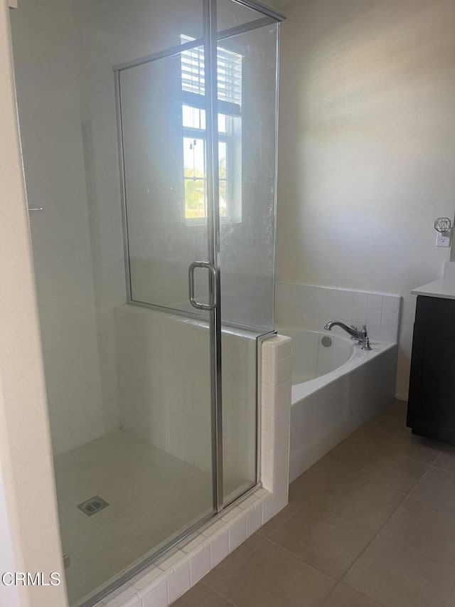 bathroom with tile patterned floors, vanity, and plus walk in shower