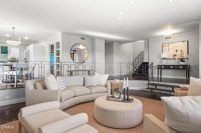 living room with hardwood / wood-style floors and built in features