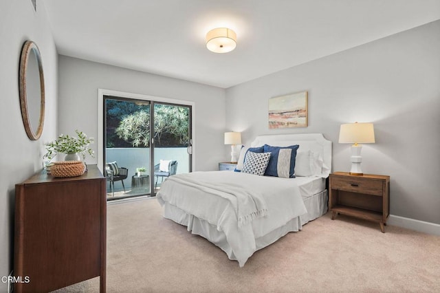 bedroom with light colored carpet and access to outside