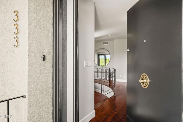 corridor featuring dark wood-type flooring