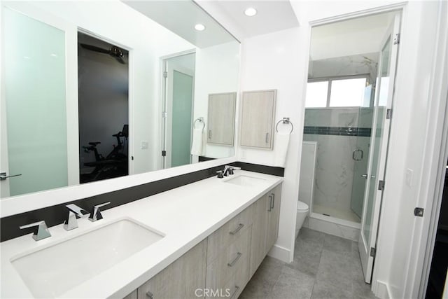 bathroom featuring toilet, walk in shower, and vanity