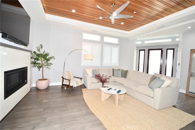 living room featuring wooden ceiling, hardwood / wood-style flooring, and a tray ceiling