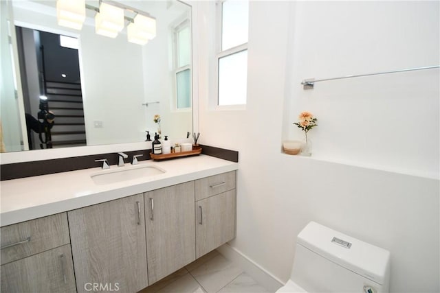 bathroom featuring toilet and vanity