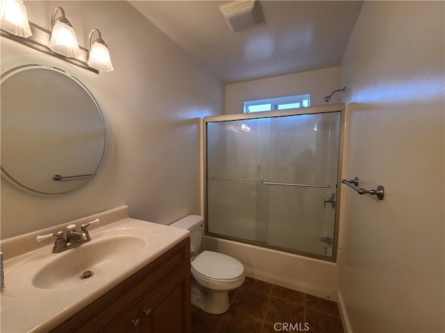 bathroom featuring visible vents, bath / shower combo with glass door, toilet, tile patterned floors, and vanity