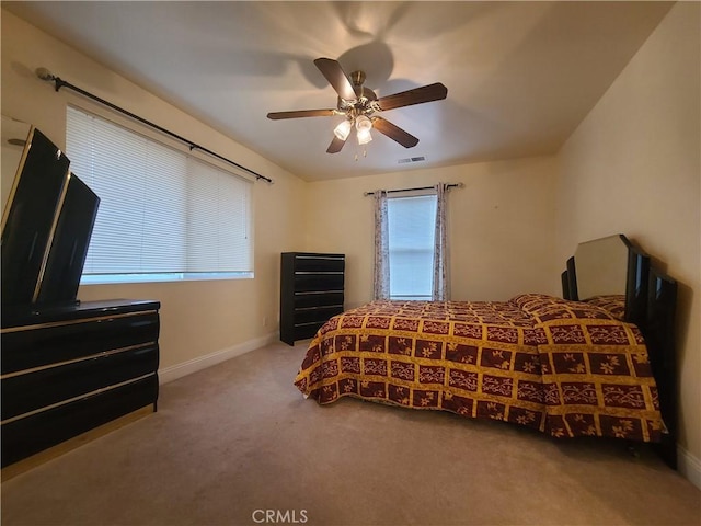 bedroom featuring ceiling fan, carpet, visible vents, and baseboards