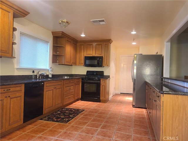 kitchen featuring tile patterned flooring, sink, and black appliances