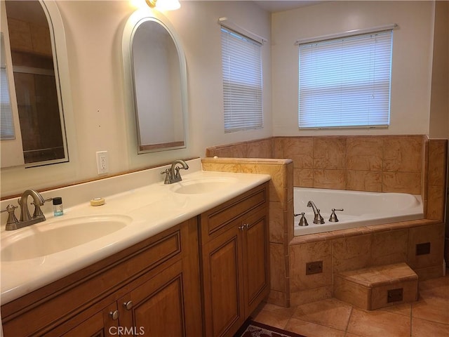 full bathroom featuring tile patterned flooring, a garden tub, a sink, and double vanity