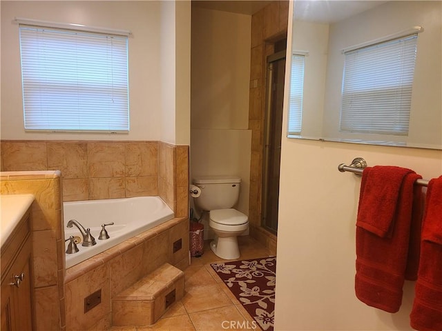 full bathroom featuring toilet, a shower with shower door, a garden tub, tile patterned flooring, and vanity