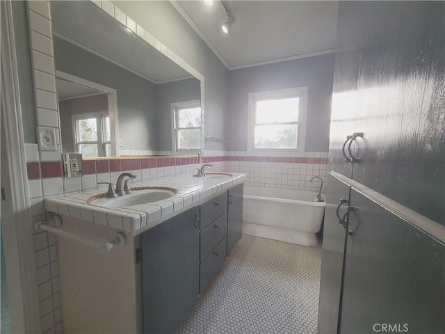 bathroom featuring vanity, tile patterned flooring, ornamental molding, and a bath