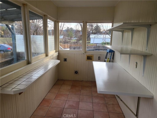 unfurnished sunroom featuring a wealth of natural light