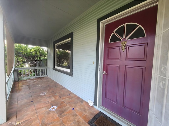 view of exterior entry featuring a porch