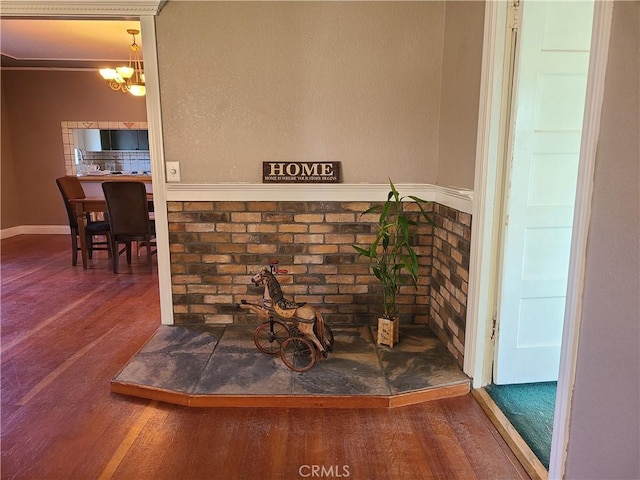 room details with an inviting chandelier and wood-type flooring