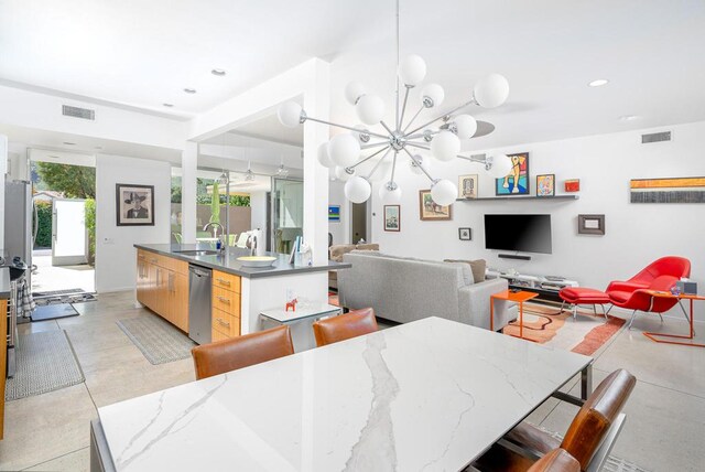 dining area with sink and a chandelier