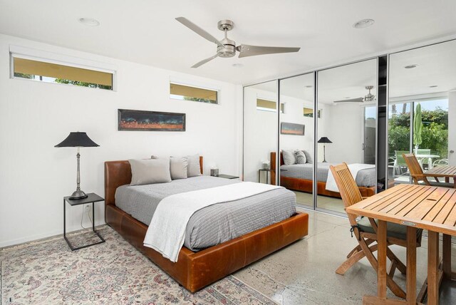 bedroom with ceiling fan, a closet, and multiple windows