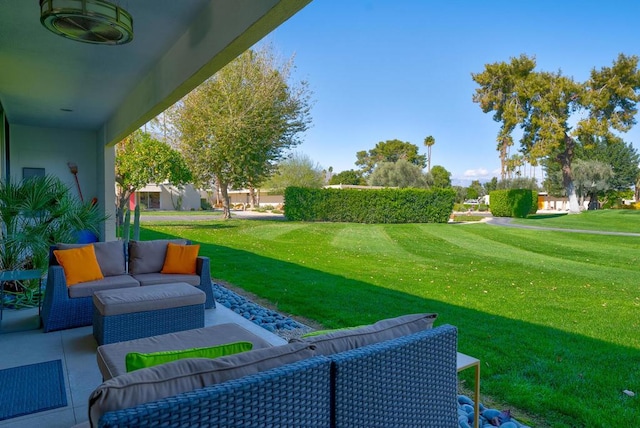 view of home's community featuring a lawn and a patio area