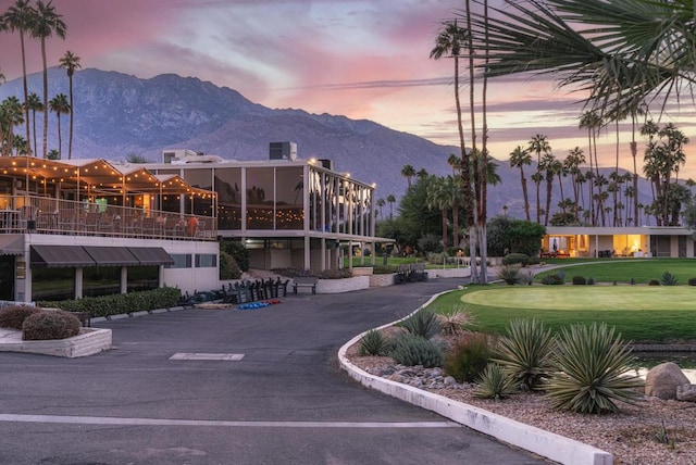 view of community featuring a lawn and a mountain view