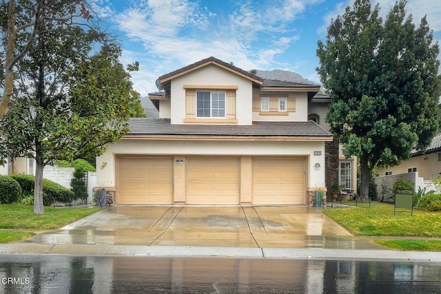 view of front of property with a garage and a front yard