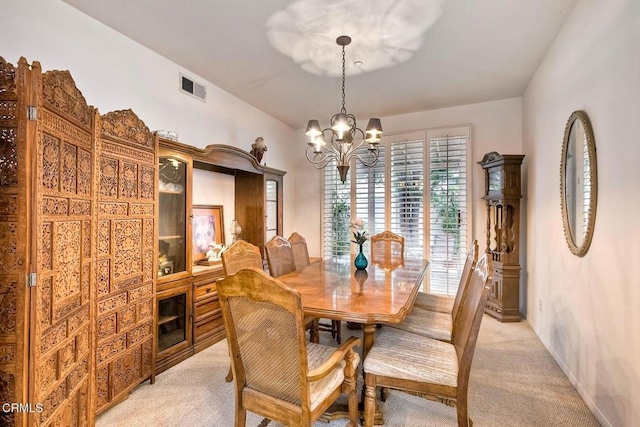 carpeted dining area featuring a notable chandelier