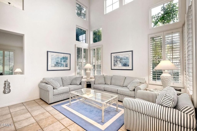 living room featuring light tile patterned flooring and a towering ceiling