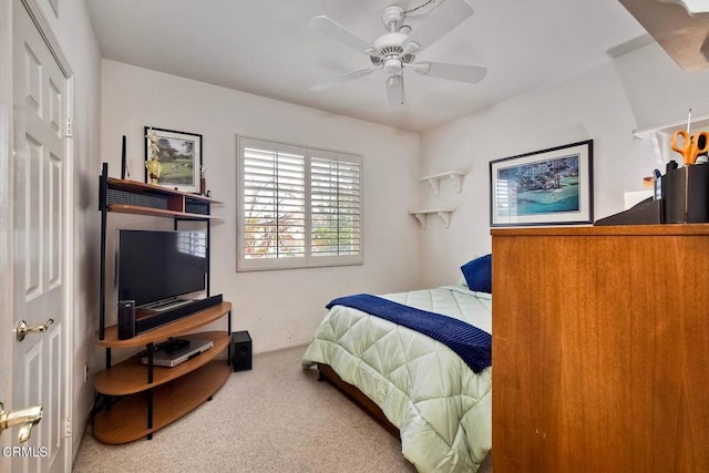 carpeted bedroom featuring a closet and ceiling fan