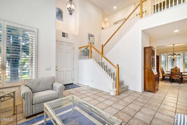 entryway featuring an inviting chandelier and a high ceiling