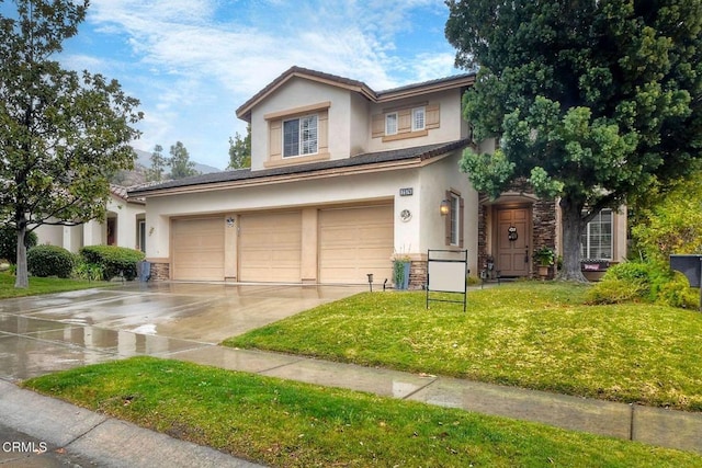 view of front of home featuring a garage and a front lawn