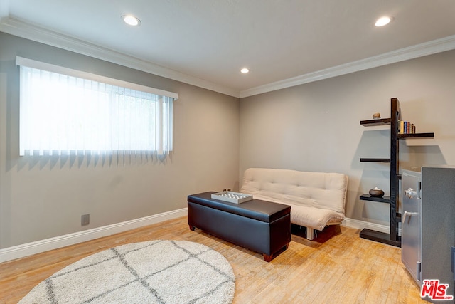 living area with ornamental molding and wood-type flooring