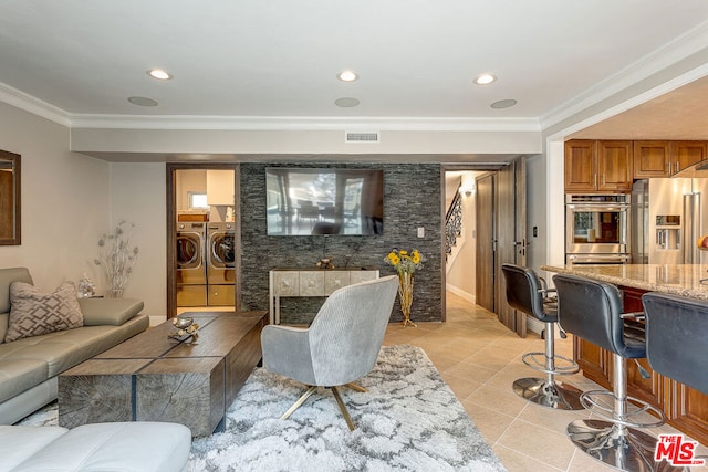 tiled living room with washer and dryer and crown molding