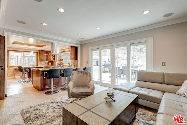 living room featuring light tile patterned floors and crown molding