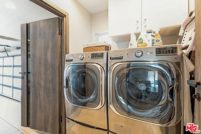 laundry room featuring cabinets and washing machine and clothes dryer